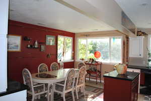 Dining space with a textured ceiling and light tile floors