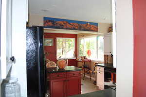 Kitchen featuring black appliances and light tile floors