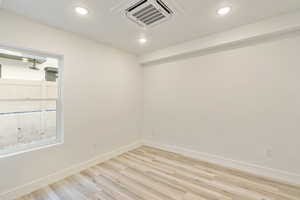 Unfurnished room featuring light hardwood / wood-style floors