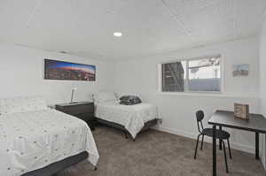 Bedroom featuring a paneled ceiling and carpet floors