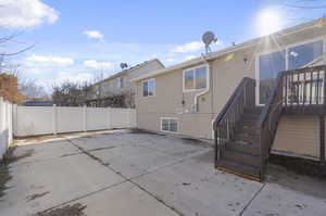 Back of property with a patio area and a wooden deck