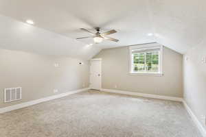 Additional living space with ceiling fan, a textured ceiling, and lofted ceiling