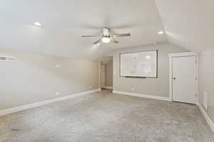 Bonus room with ceiling fan, carpet floors, and lofted ceiling