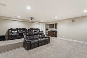 Carpeted home theater with sink