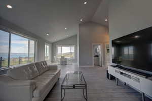 Living room and dining room with high vaulted ceiling, views of Bear Lake