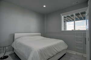 Bedroom with wood-type flooring