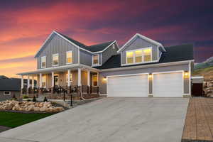 View of front of property featuring a garage and a porch