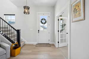 Entrance foyer with light hardwood / wood-style flooring