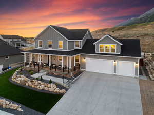 View of front of house with a garage and a porch