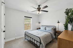 Carpeted bedroom with ceiling fan