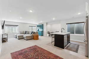 Living room featuring light carpet and sink