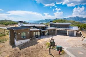 View of front of property featuring a garage and a mountain view