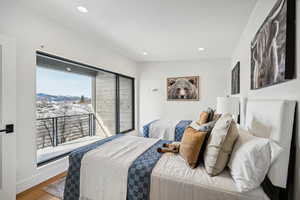 Bedroom with a mountain view and wood-type flooring