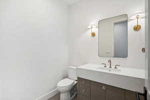 Bathroom with tile patterned flooring, vanity, and toilet