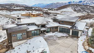 Snowy aerial view featuring a mountain view