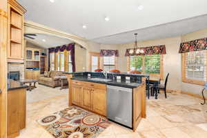 Kitchen featuring sink, a healthy amount of sunlight, stainless steel dishwasher, and light tile floors