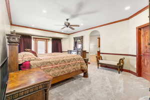 Primary bedroom featuring crown molding and ceiling fan