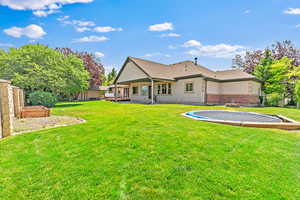 Back of house featuring a patio and a lawn