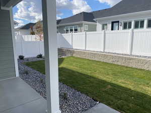 Covered porch and View of yard.  Price includes full front and back yard landscaping, fencing and maintenance