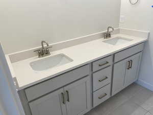 Primary Owners Bathroom with adult height vanity and tiled floors