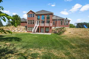 The basement access, back patio and surrounded by property.