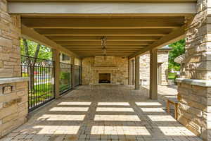 View of terrace featuring an outdoor stone fireplace at Clubhouse