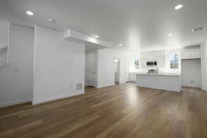 Unfurnished living room featuring hardwood / wood-style flooring