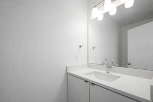 Bathroom featuring vanity with extensive cabinet space