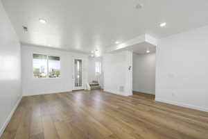 Unfurnished living room with light wood-type flooring