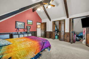 Bedroom with beamed ceiling, carpet flooring, a closet, and ceiling fan