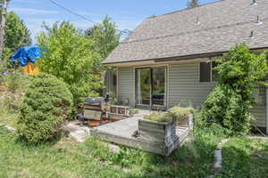 Rear view of property featuring a deck