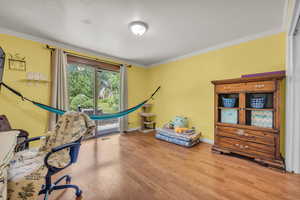 Office area featuring ornamental molding and hardwood / wood-style floors