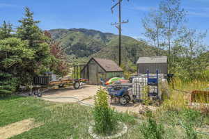 View of yard with a shed and a mountain view