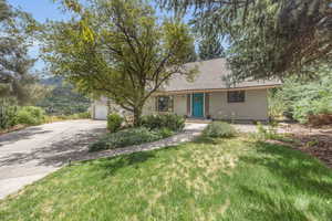 View of front of house featuring a garage and a front lawn