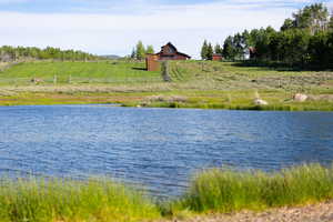 View of the Club house & one of the several stocked fishing ponds within  the development.