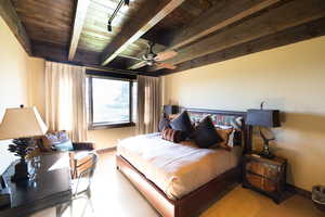 Bedroom with wooden ceiling, ceiling fan, and beam ceiling