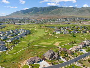 Aerial view of residential area featuring a local golf course and a water and mountain view