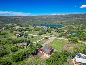 Drone / aerial view featuring a water and mountain view