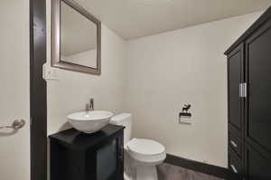 Bathroom with dark hardwood flooring, and vanity