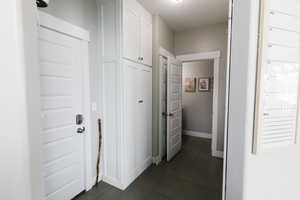 Corridor with dark tile floors