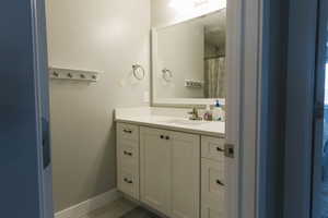 Bathroom featuring tile flooring and vanity with extensive cabinet space