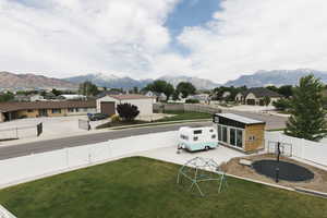 View of yard with a patio area, an outdoor structure, and a mountain view