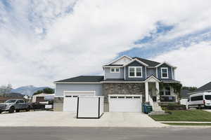 View of front of home with a garage and a mountain view