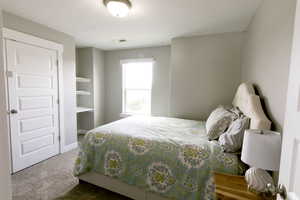 Bedroom featuring a textured ceiling and carpet floors