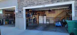 Garage featuring white fridge with ice dispenser