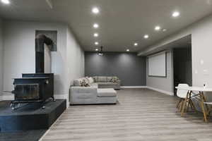 Living room featuring wood-type flooring and a wood stove