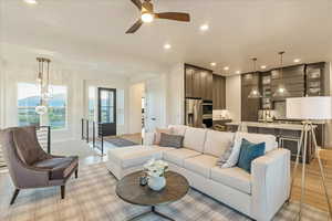 Living room featuring light wood-type flooring and ceiling fan