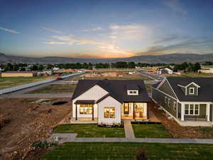 Modern farmhouse style home featuring a mountain view and a yard