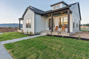 View of front of home featuring a front yard and covered porch