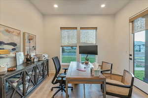 Office area with light hardwood / wood-style floors